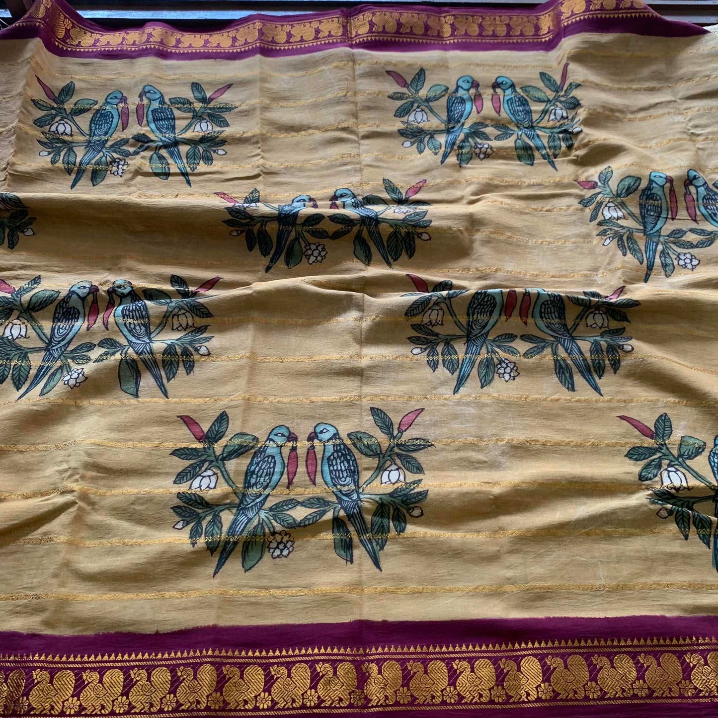 Parrot- chilli Kalamkari Hand Painted on a Madurai Velthari Sungudi Cotton saree.