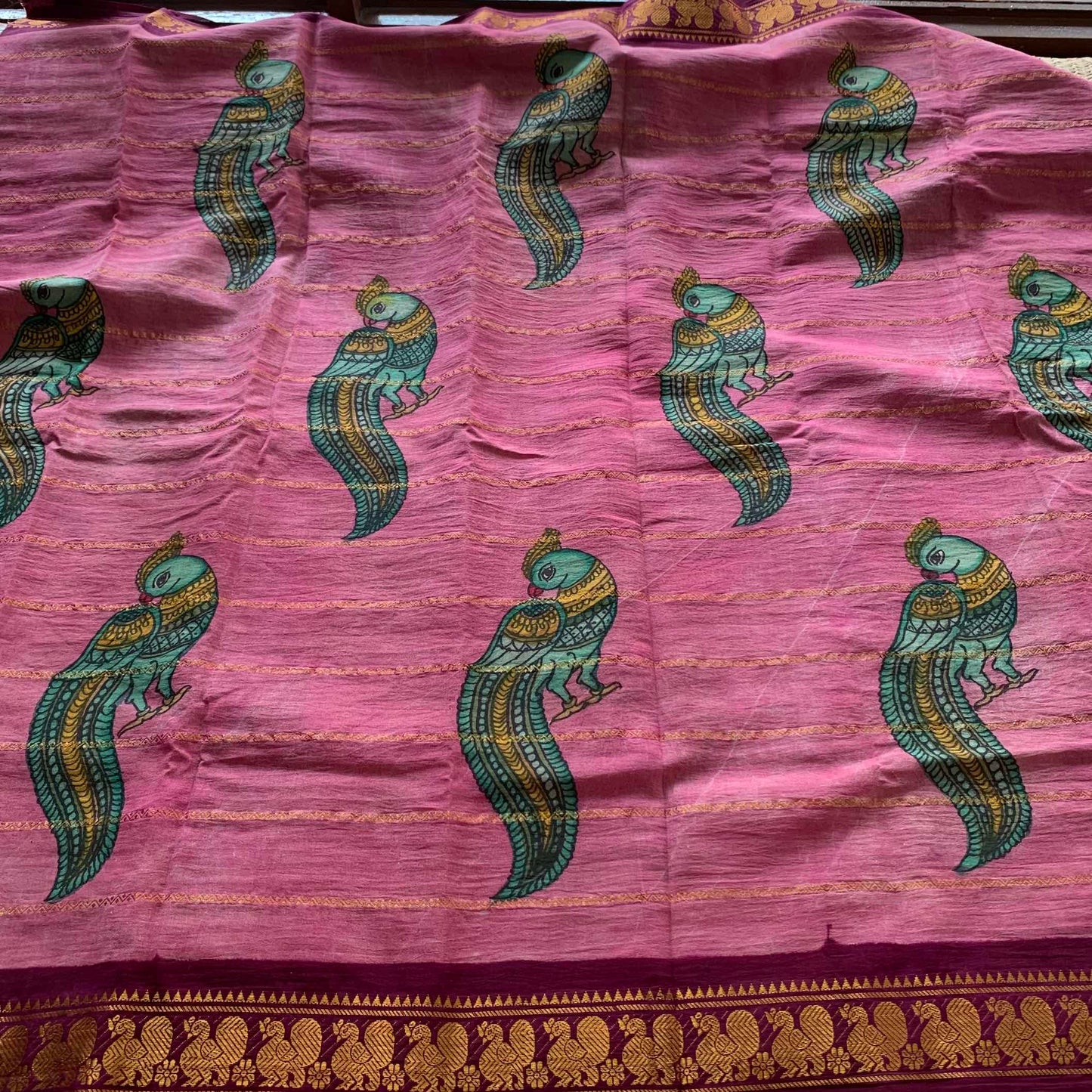 Classic Parrot- Kalamkari Hand Painted on a Madurai Velthari Sungudi Cotton saree.